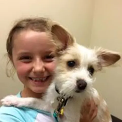 Girl holding small dog