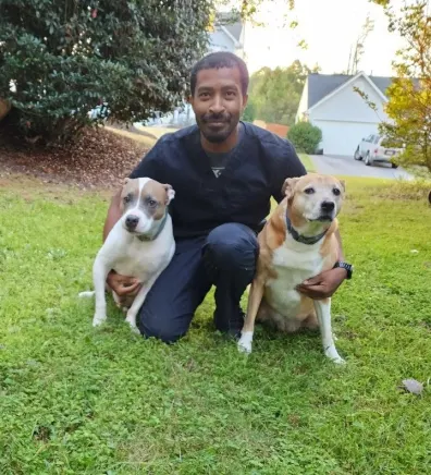 Jarrett sitting next to two dogs