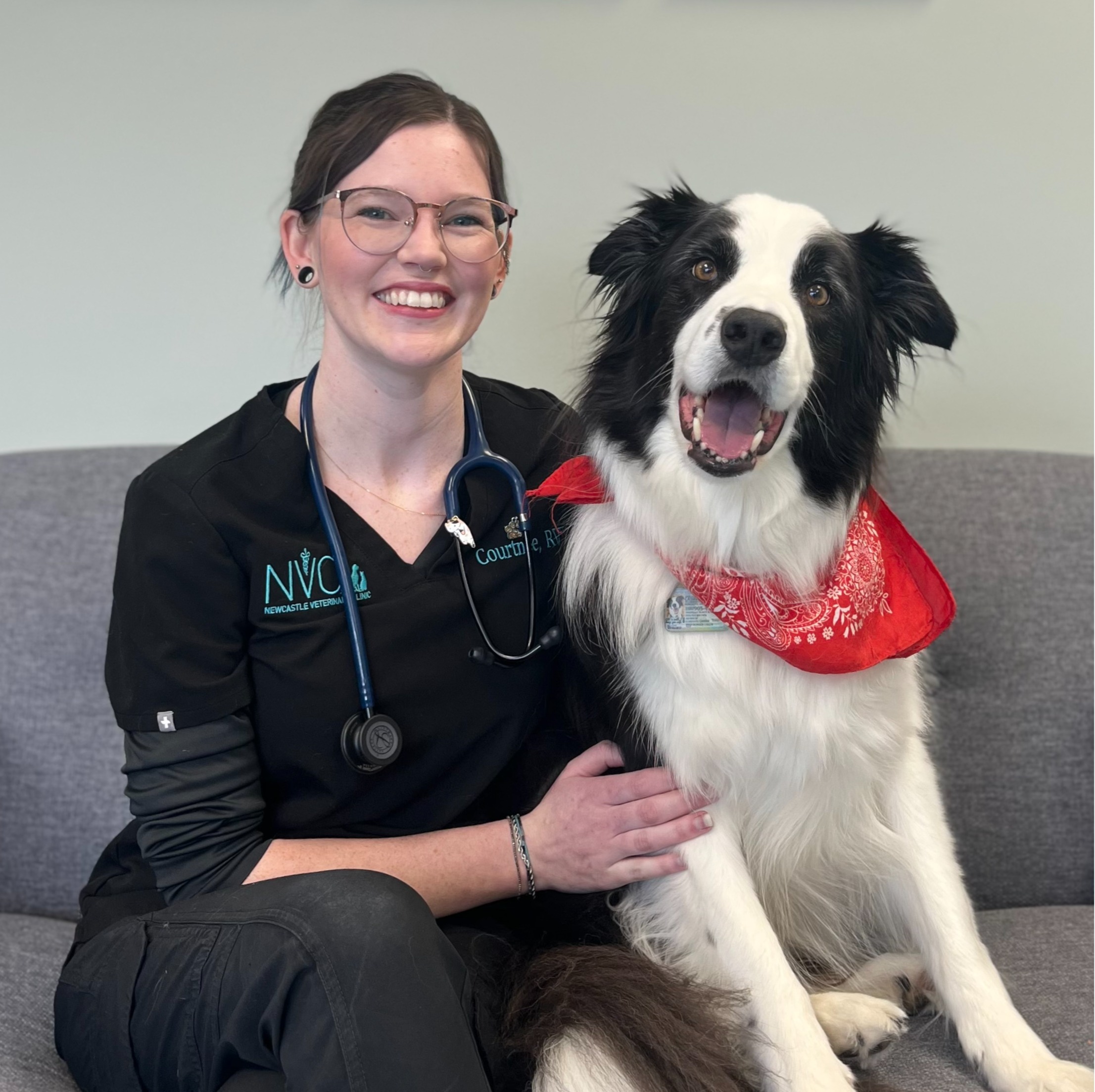 Staff photo of Courtnee posing with a dog