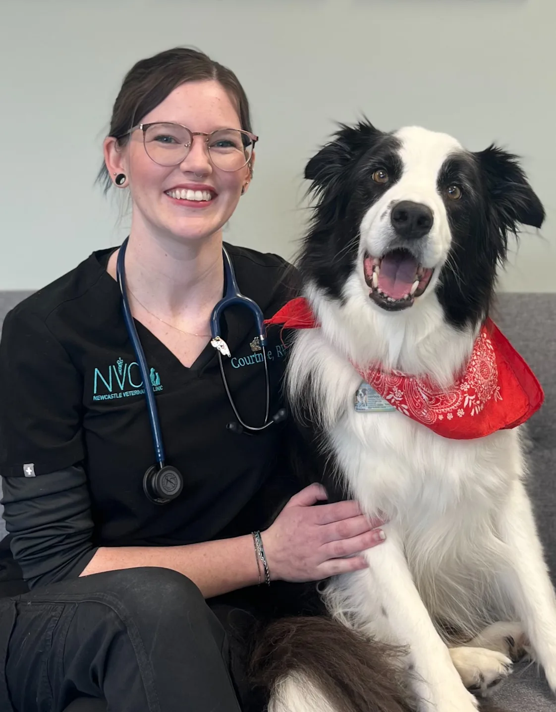 Staff photo of Courtnee posing with a dog Staff photo of Courtnee posing with a dog
