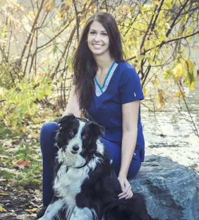 Rissa sitting with a black and white dog