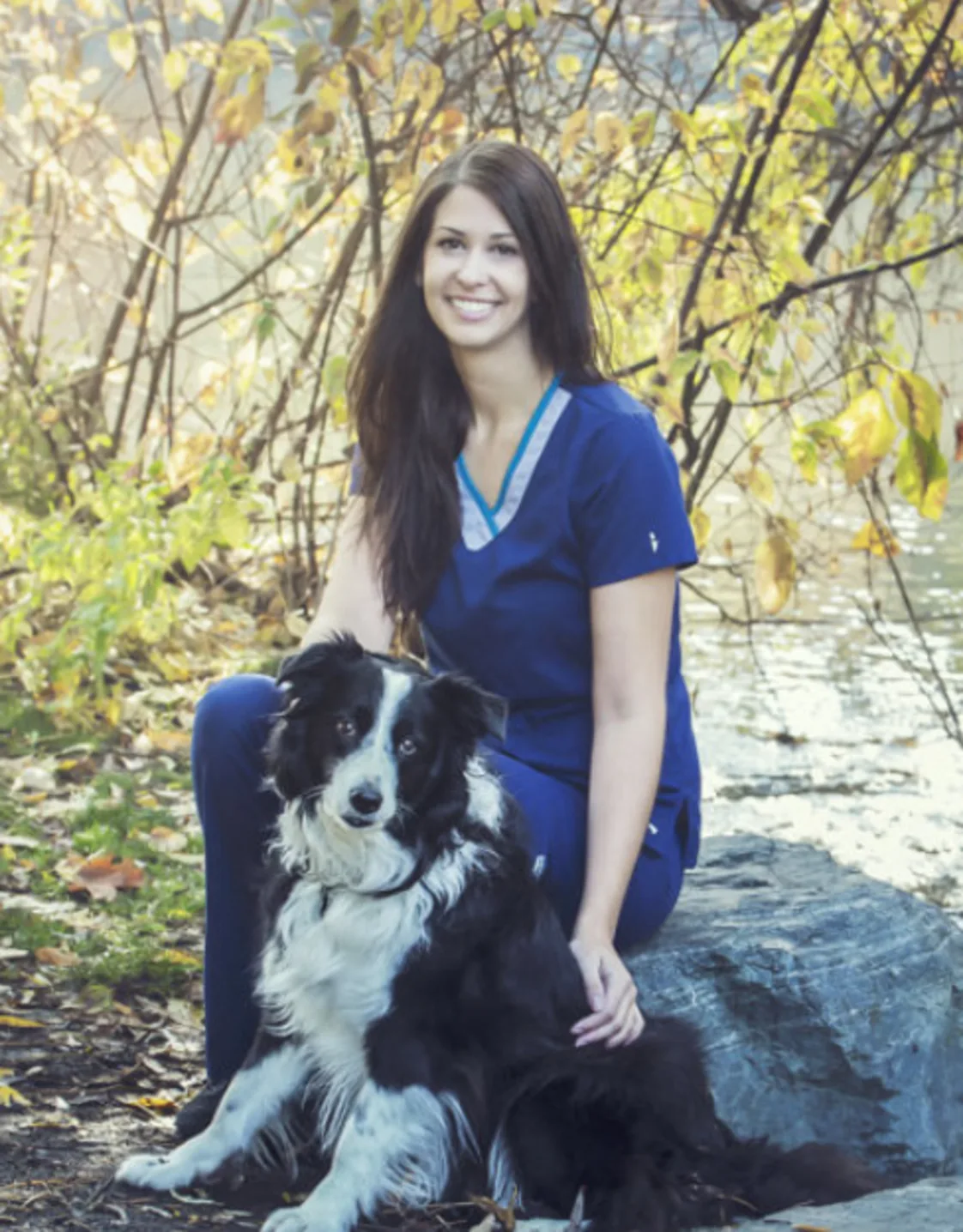Rissa sitting with a black and white dog Rissa sitting with a black and white dog