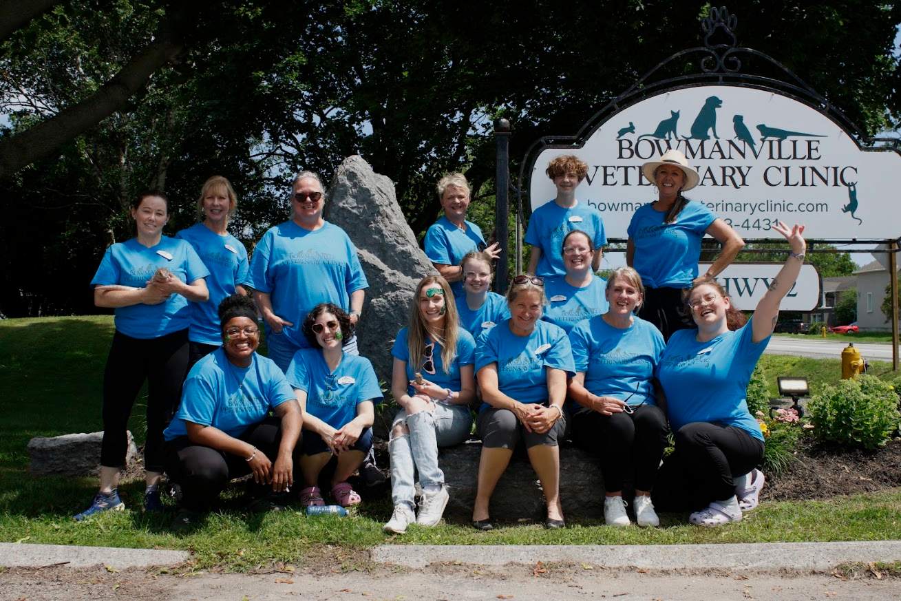 Staff in front of clinic sign.
