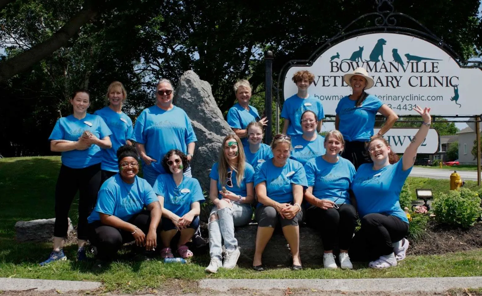 Staff in front of clinic sign. Staff in front of clinic sign.