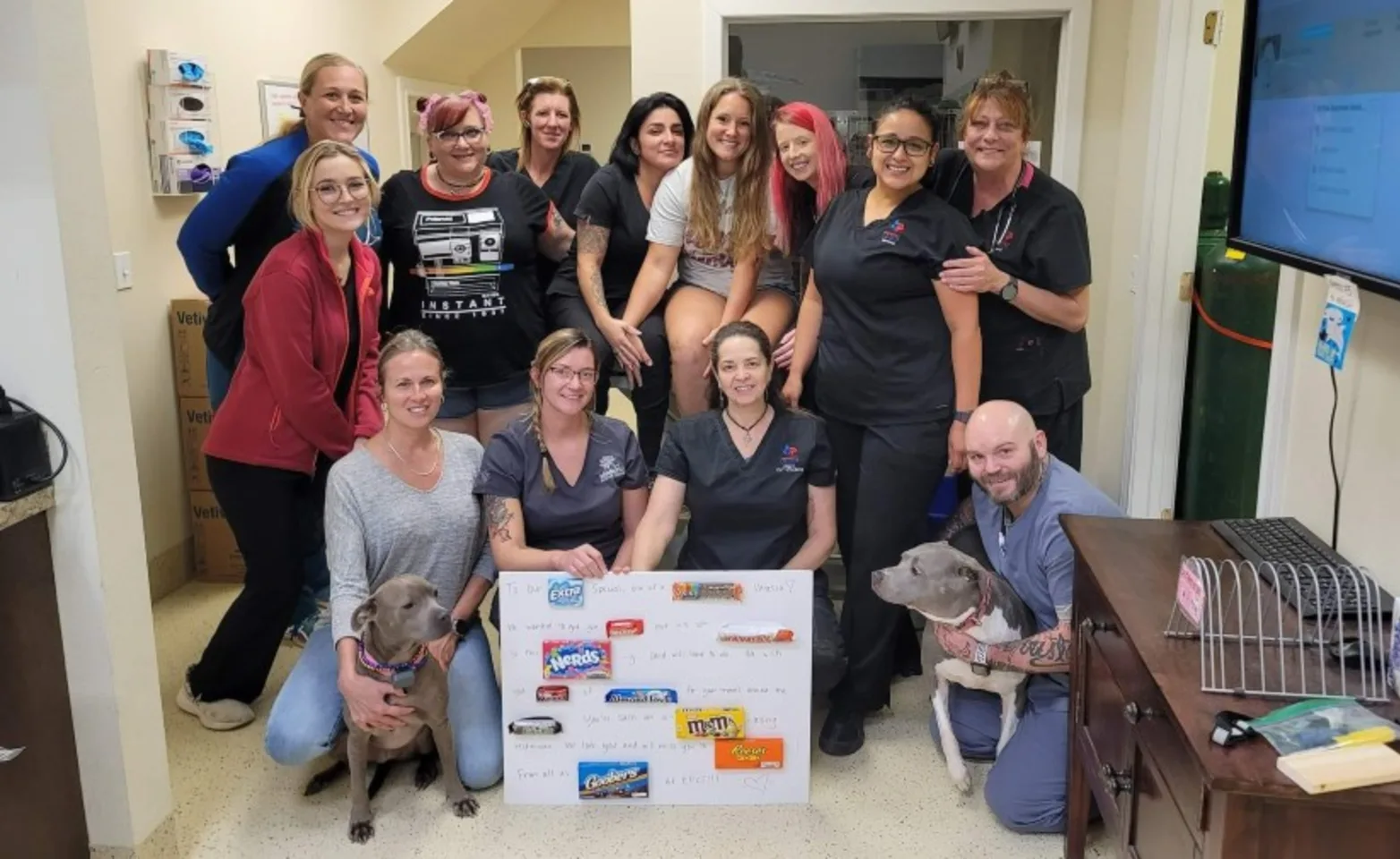 Group of Staff Members Holding a Poster Board Group of Staff Members Holding a Poster Board