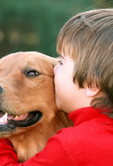 child hugging dog