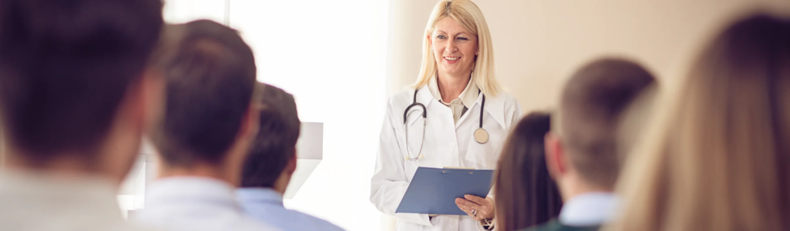 A doctor talking to pet parents. A doctor talking to pet parents.