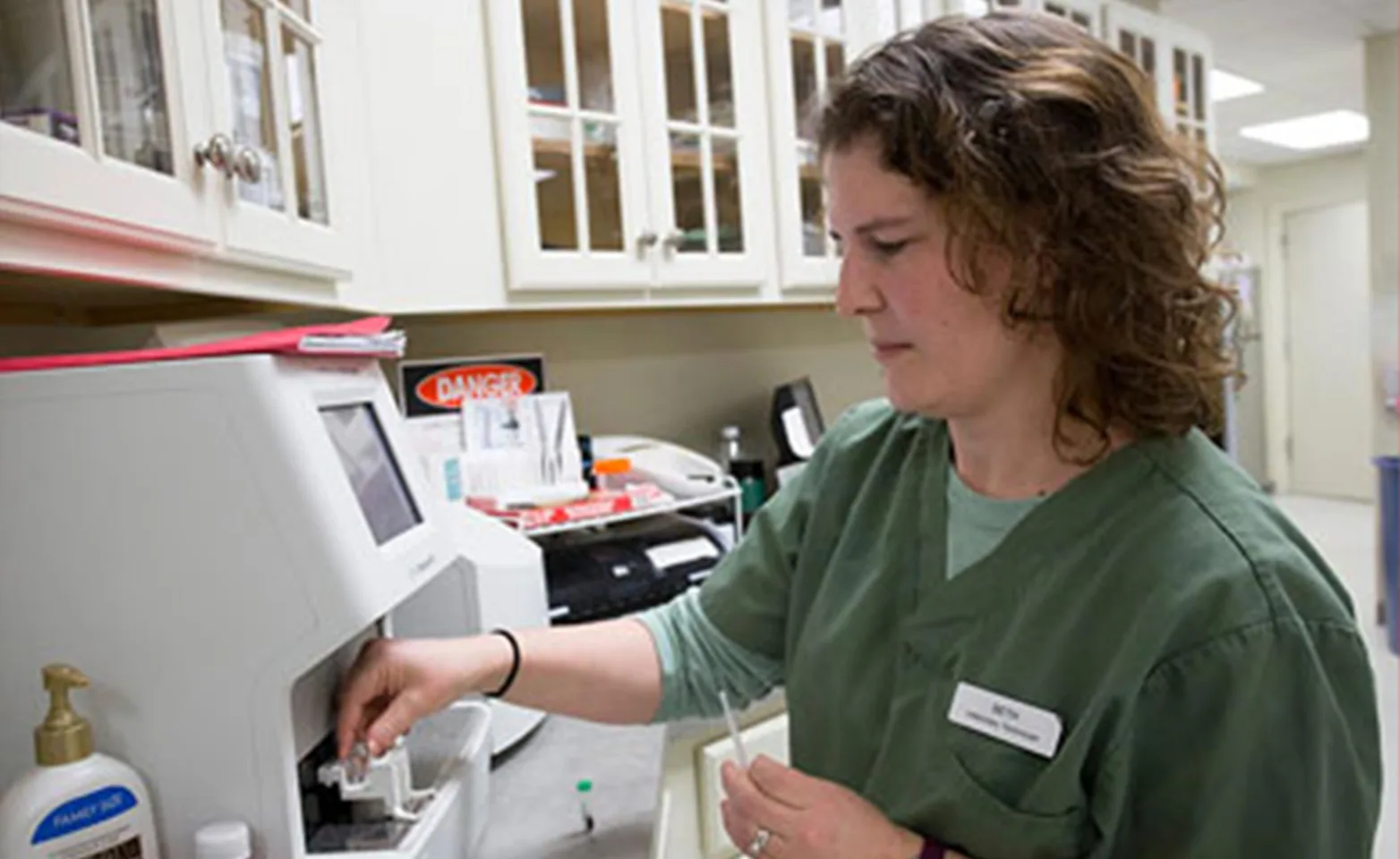 Staff doing lab work on a medical equipment