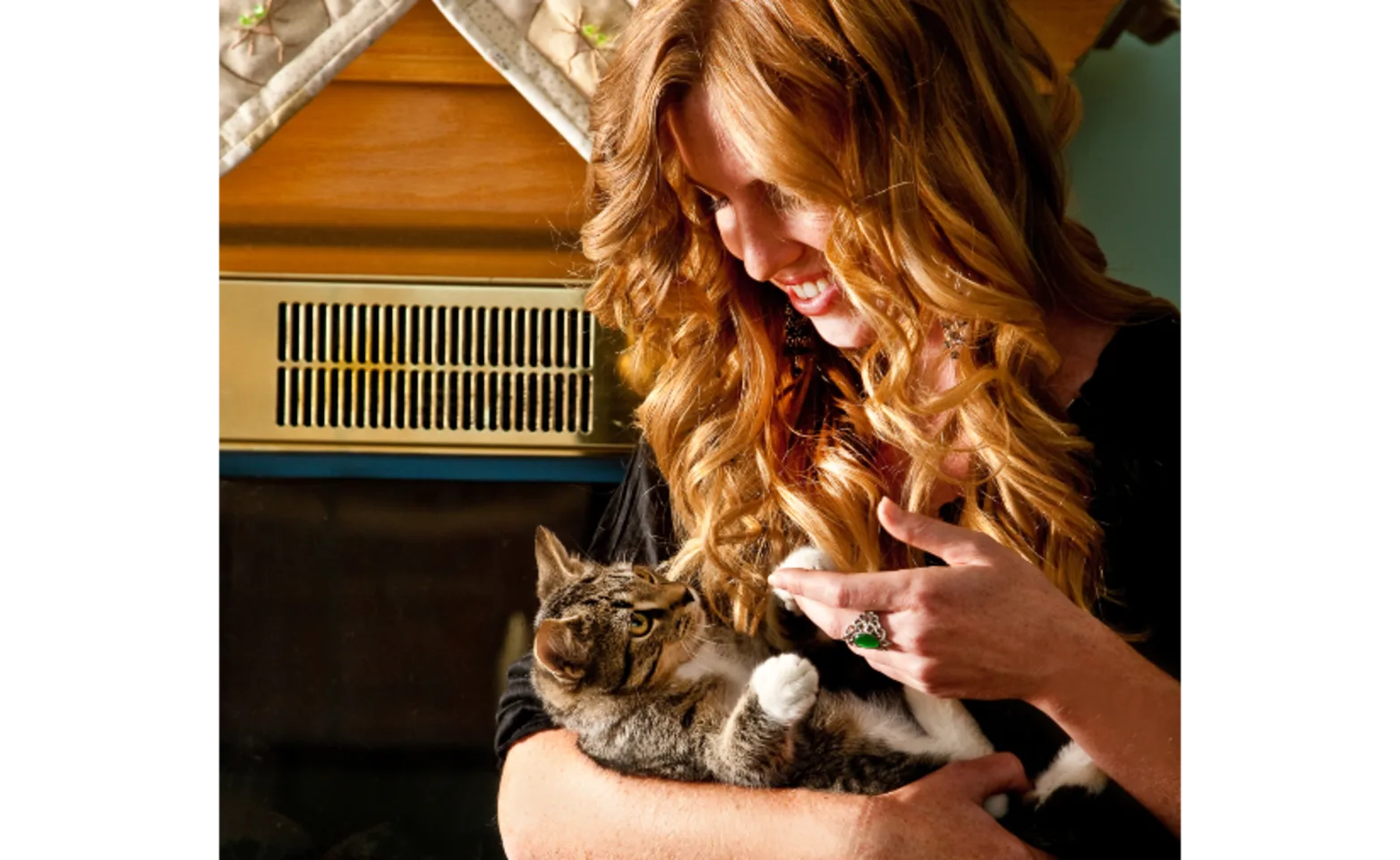 A woman holding a grey cat in her arms A woman holding a grey cat in her arms