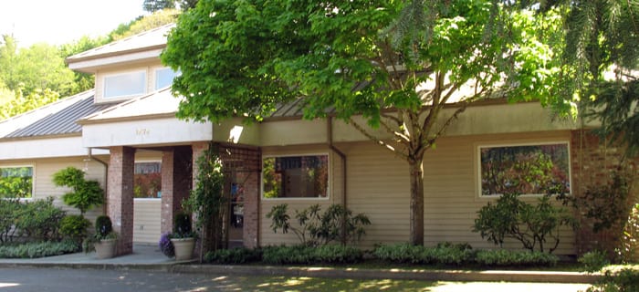 Poulsbo Marina Veterinary Clinic Exterior Shot of the front of their building. There are trees surrounding the building.