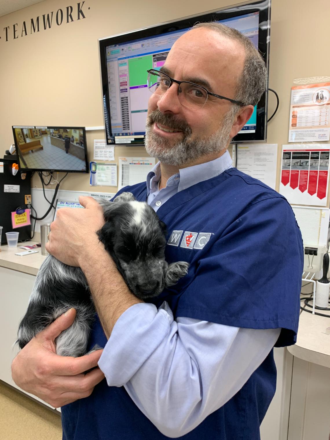 Pete holding Ethel, a black and white dog