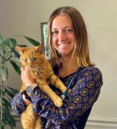 Dr. Madalyn Trowbridge holding an orange tabby cat Dr. Madalyn Trowbridge holding an orange tabby cat