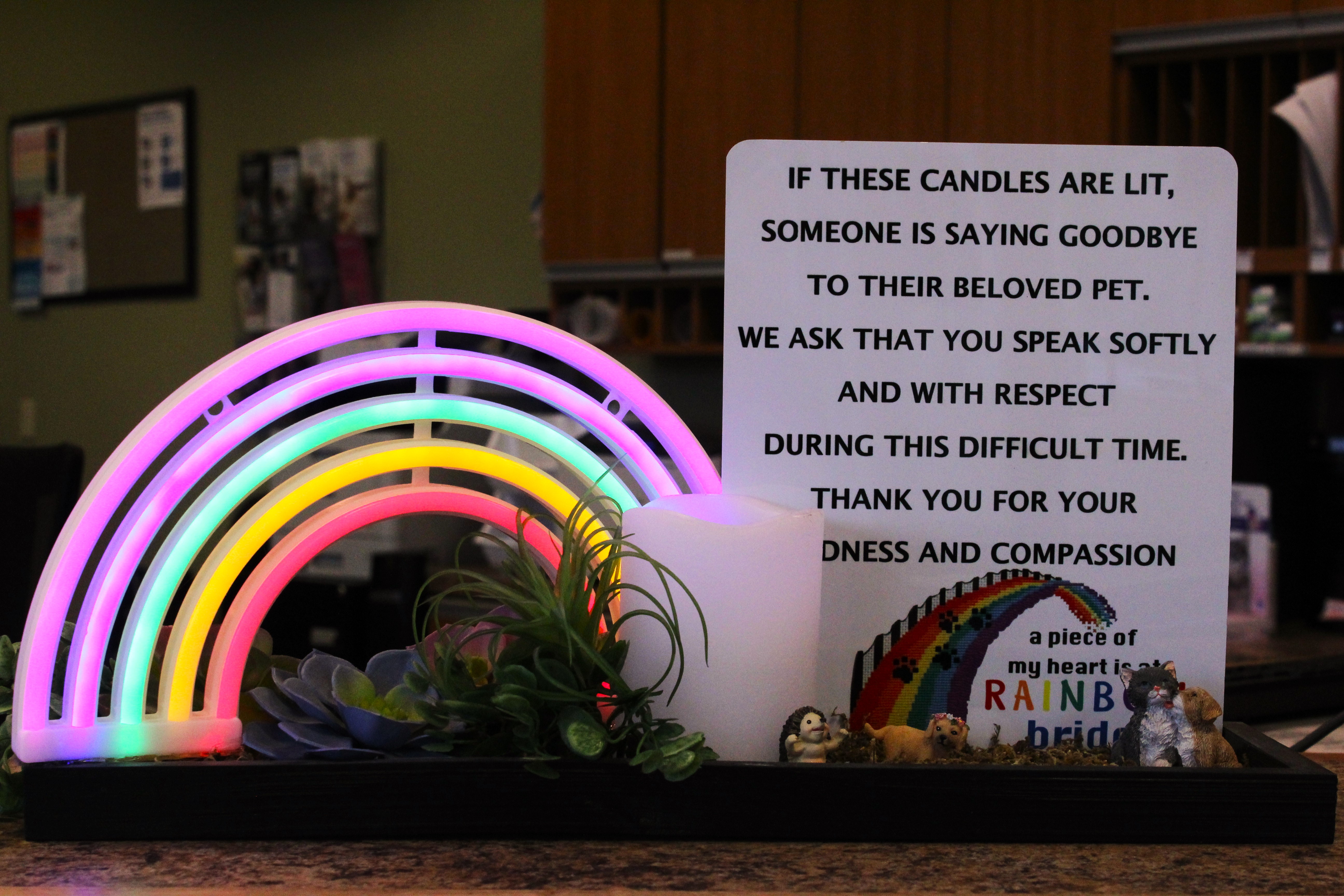 Rainbow bridge sign at the front of the reception desk.