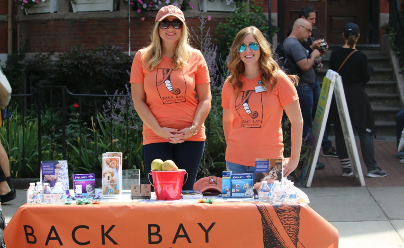 Two staff members standing behind a table Two staff members standing behind a table
