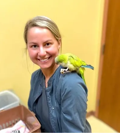 Veterinary Technician Kailee with a yellow bird. Veterinary Technician Kailee with a yellow bird.