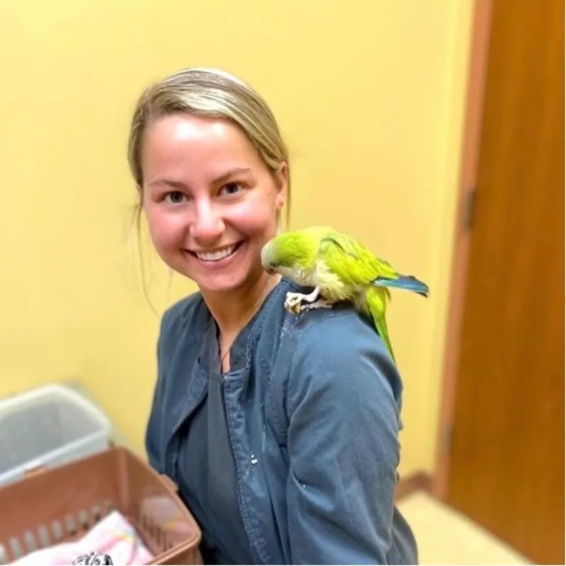 Veterinary Technician Kailee with a yellow bird. Veterinary Technician Kailee with a yellow bird.