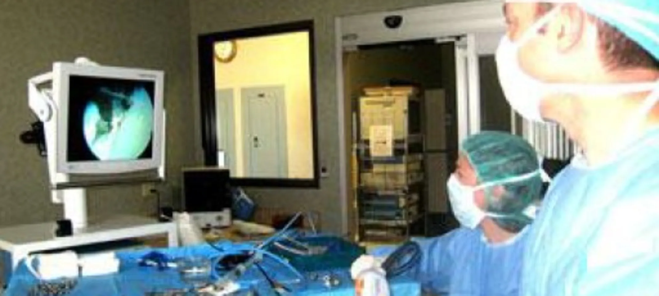 Surgeons looks at a screen during surgery. Surgeons looks at a screen during surgery.