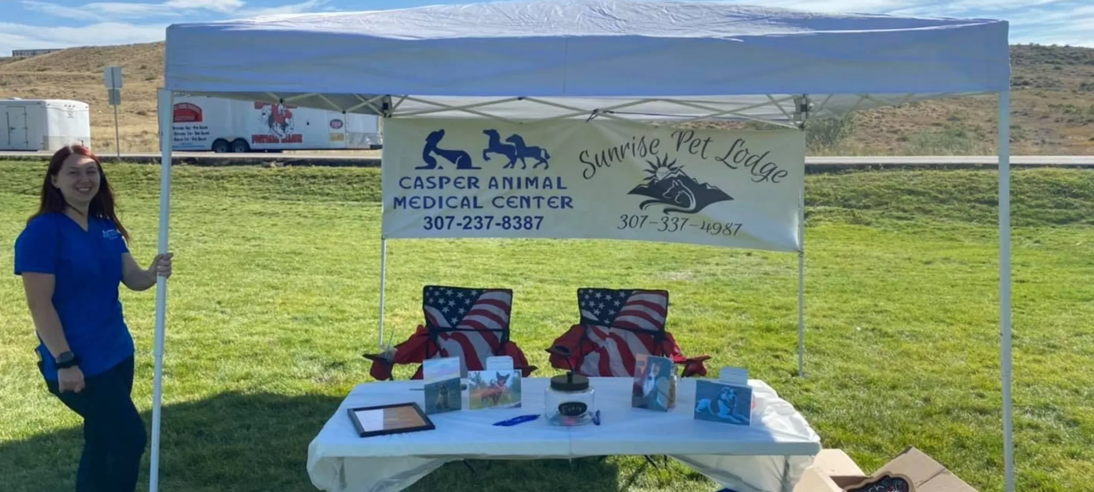 Woman standing next to a tent for Bark for Life event.