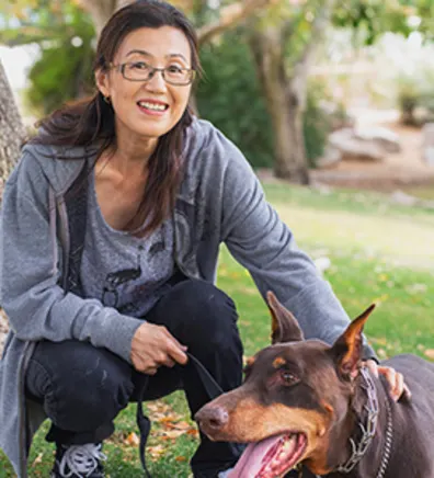 Satoko DeRollo with a black and brown dog Satoko DeRollo with a black and brown dog