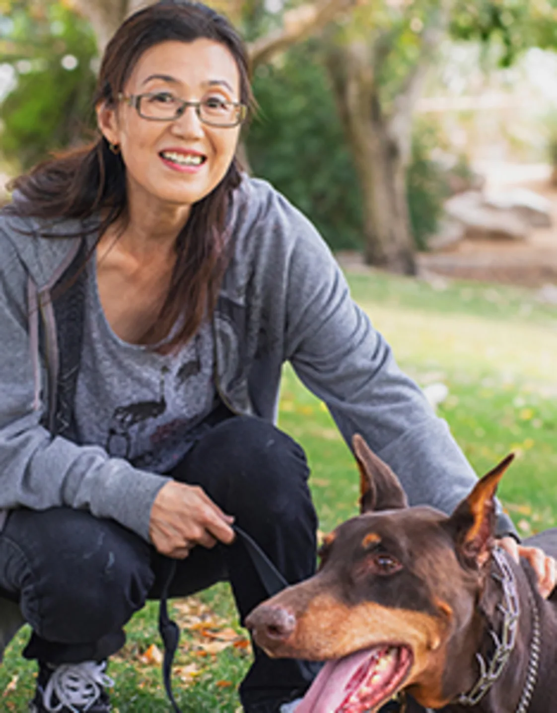 Satoko DeRollo with a black and brown dog Satoko DeRollo with a black and brown dog