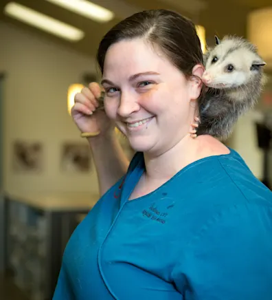 Shelise with an opossum on her shoulder Shelise with an opossum on her shoulder