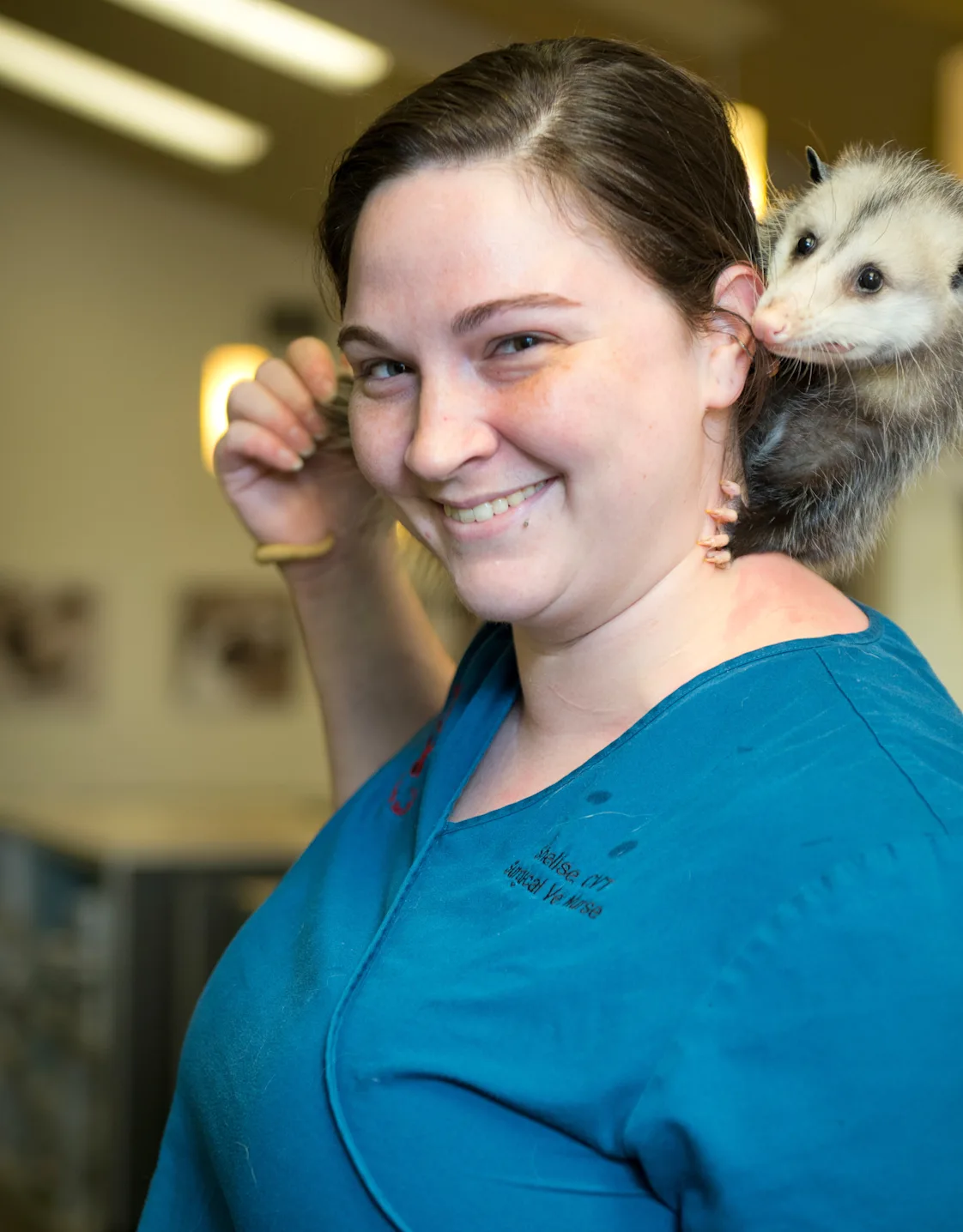 Shelise with an opossum on her shoulder Shelise with an opossum on her shoulder
