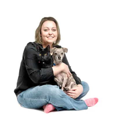A portrait photo of Veterinary Assistant Brittany holding her dog and cat A portrait photo of Veterinary Assistant Brittany holding her dog and cat