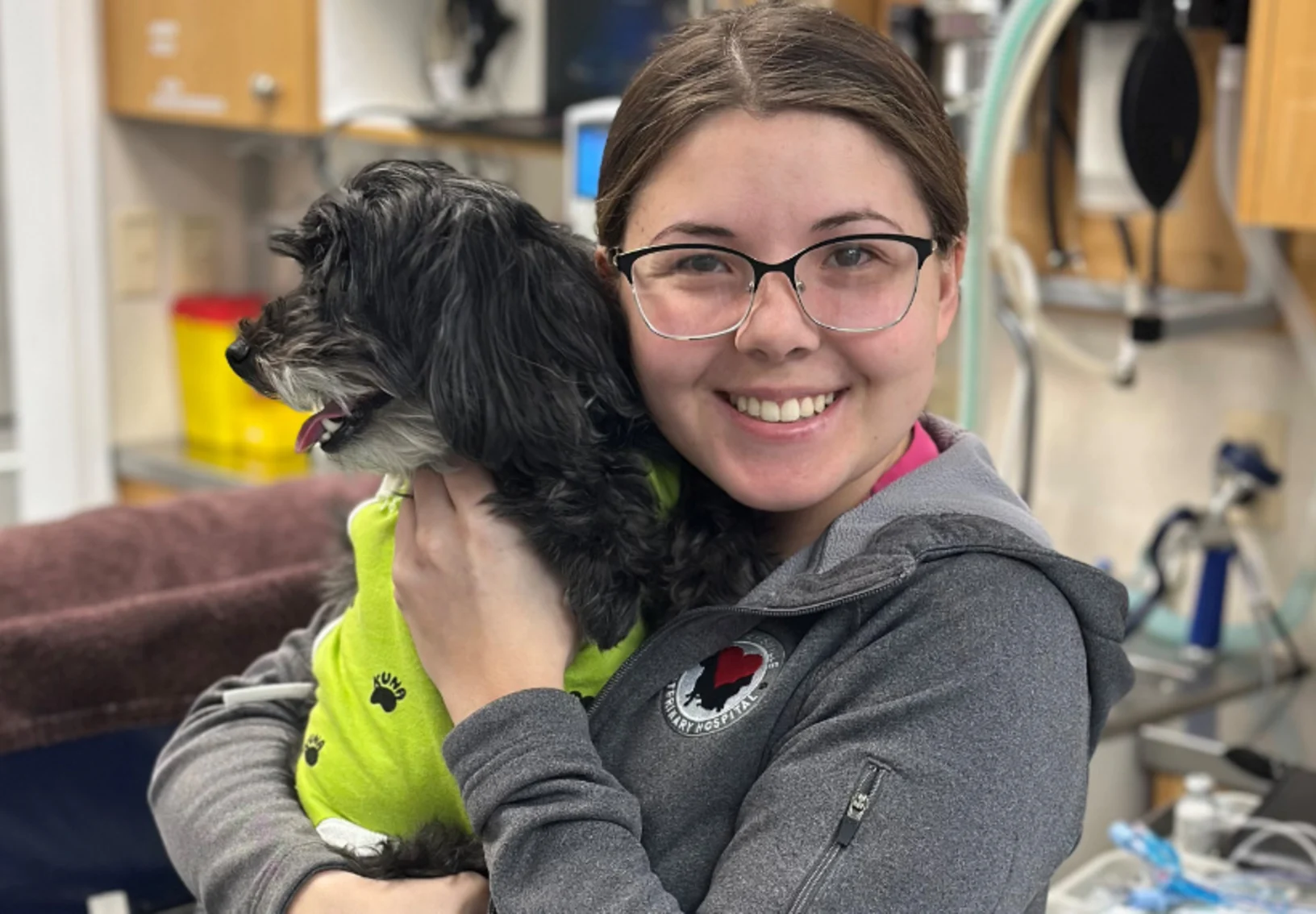 Staff Holding Dog Smiling at Camera Staff Holding Dog Smiling at Camera