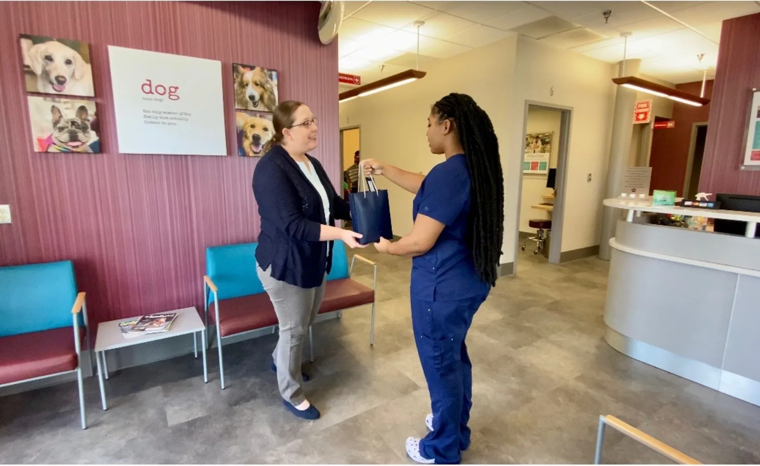 Staff member handing bag to client Staff member handing bag to client