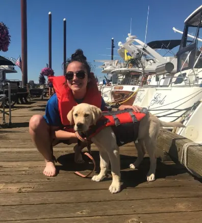 Katilyn with her dog on a dock
