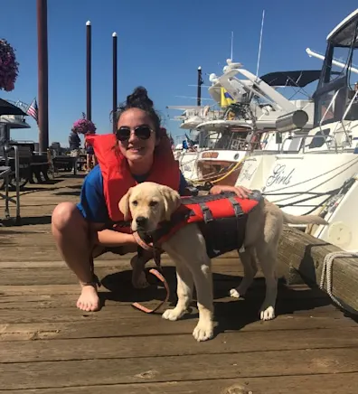 Katilyn with her dog on a dock