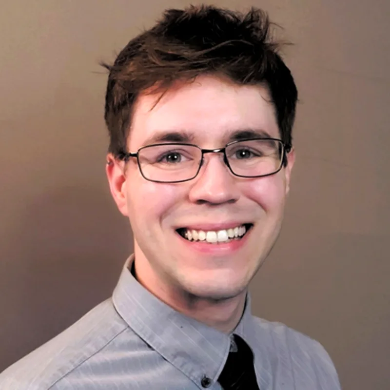 Wil MacAllister smiling standing in front of a tan wall Wil MacAllister smiling standing in front of a tan wall