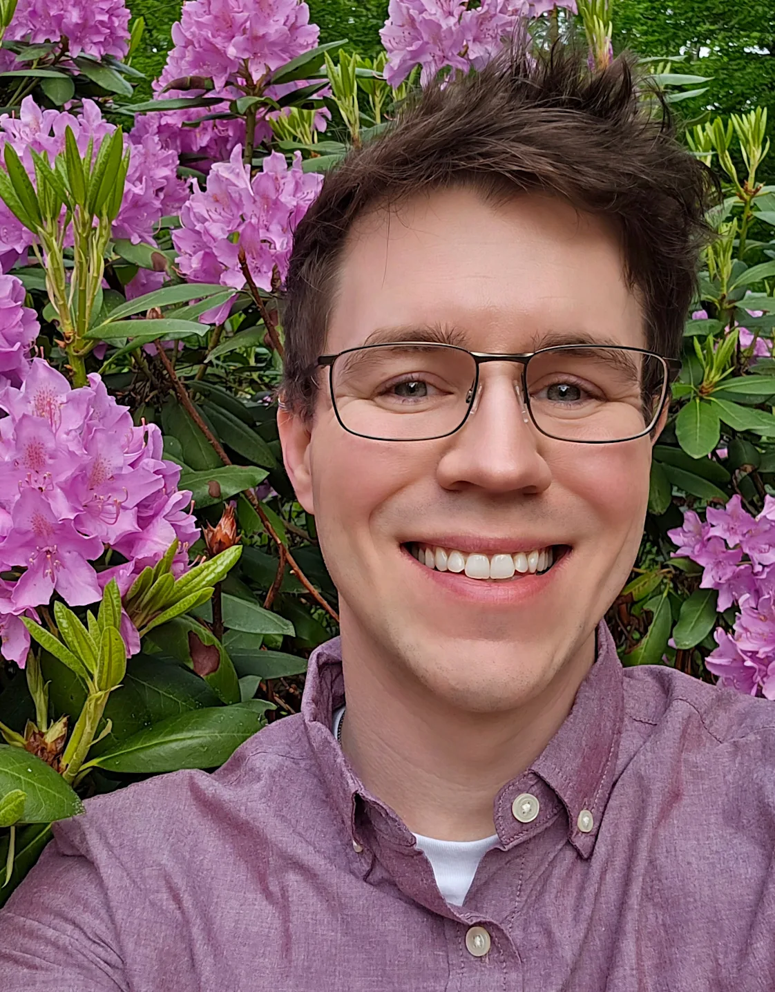 Wil MacAllister smiling standing in front of a tan wall Wil MacAllister smiling standing in front of a tan wall