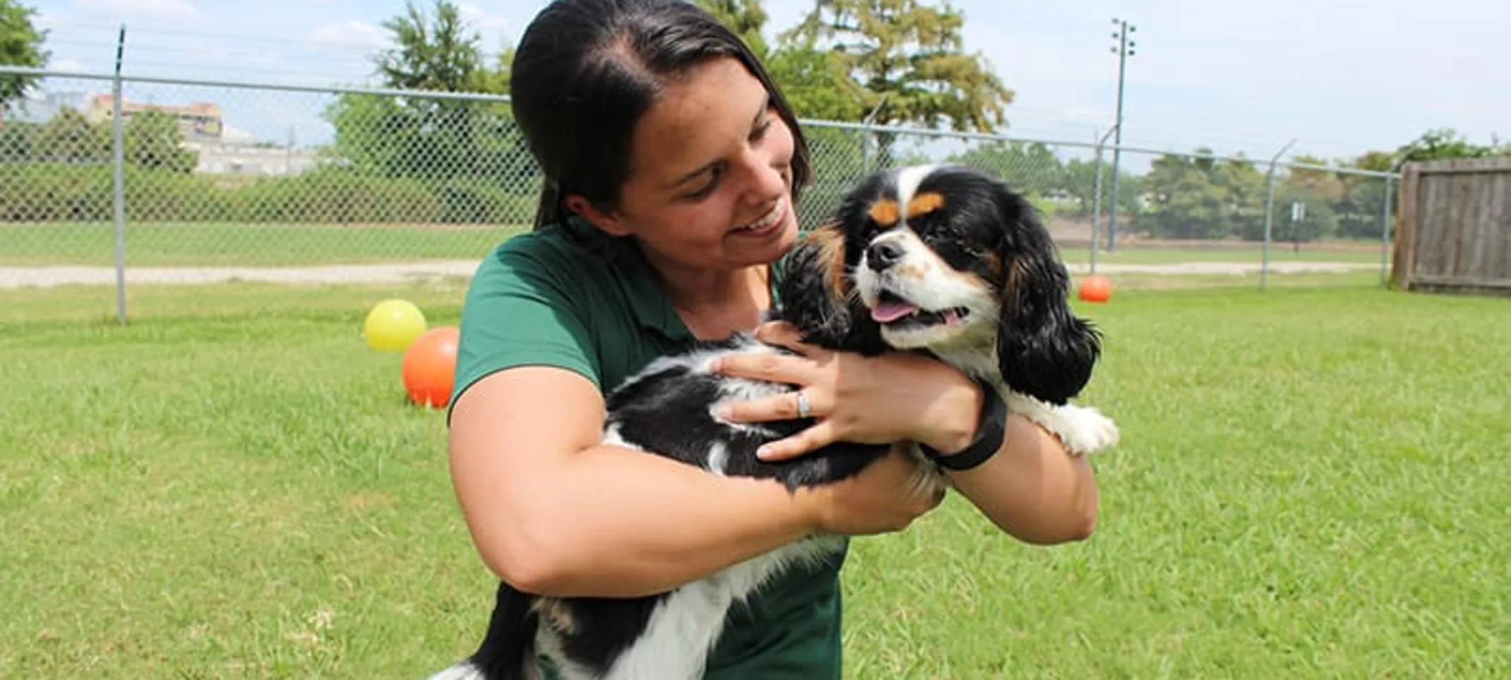 Staff holding dog at Rover Oaks Pet Resort Staff holding dog at Rover Oaks Pet Resort