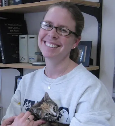 Julie holding onto a kitten. Julie holding onto a kitten.