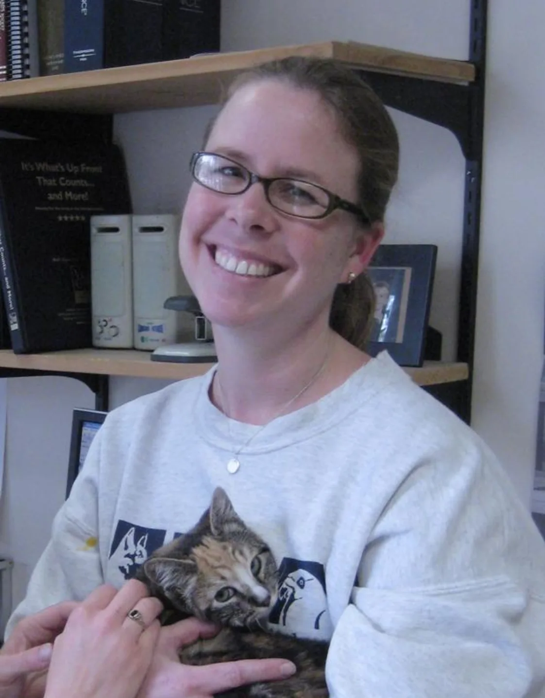 Julie holding onto a kitten. Julie holding onto a kitten.