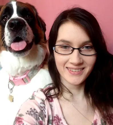Ashley smiling next to a Saint Bernard. Ashley smiling next to a Saint Bernard.
