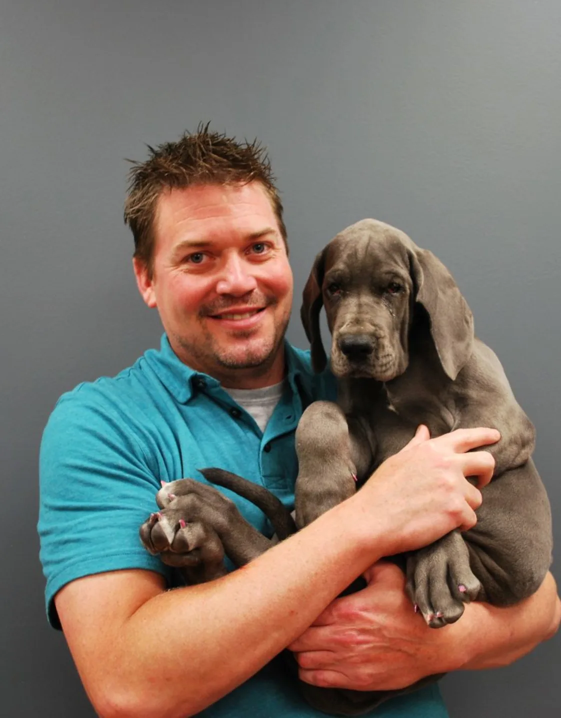 Dr. Robert B. Buchanan III holding a grey dog Dr. Robert B. Buchanan III holding a grey dog