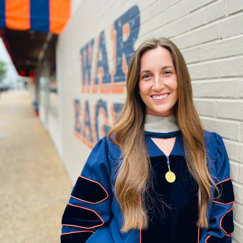 Dr. Kerrigan Steinsultz smiling in a hallway. Dr. Kerrigan Steinsultz smiling in a hallway.