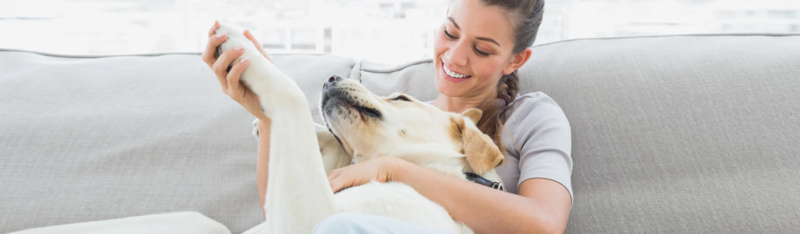 Woman Laying with Dog on Couch