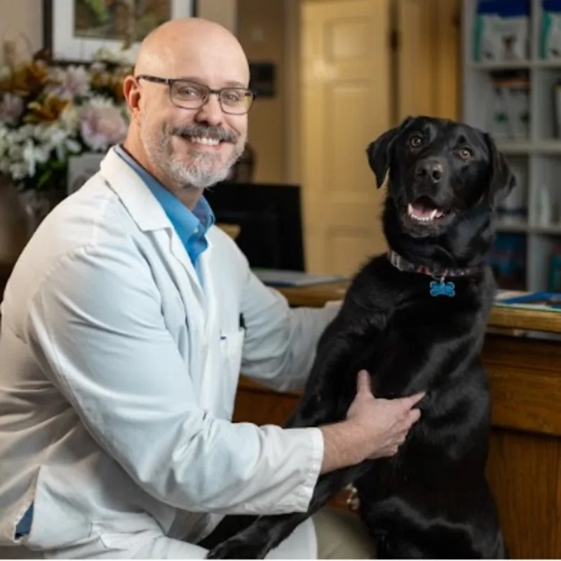 Dr. Anthony Brown holding a dog. Dr. Anthony Brown holding a dog.