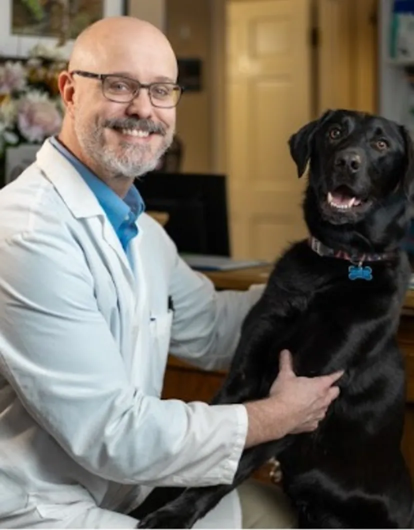 Dr. Anthony Brown holding a dog.