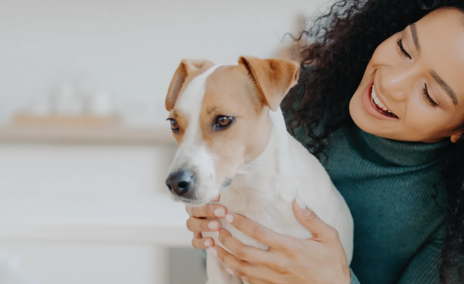 Woman looking at dog holding up