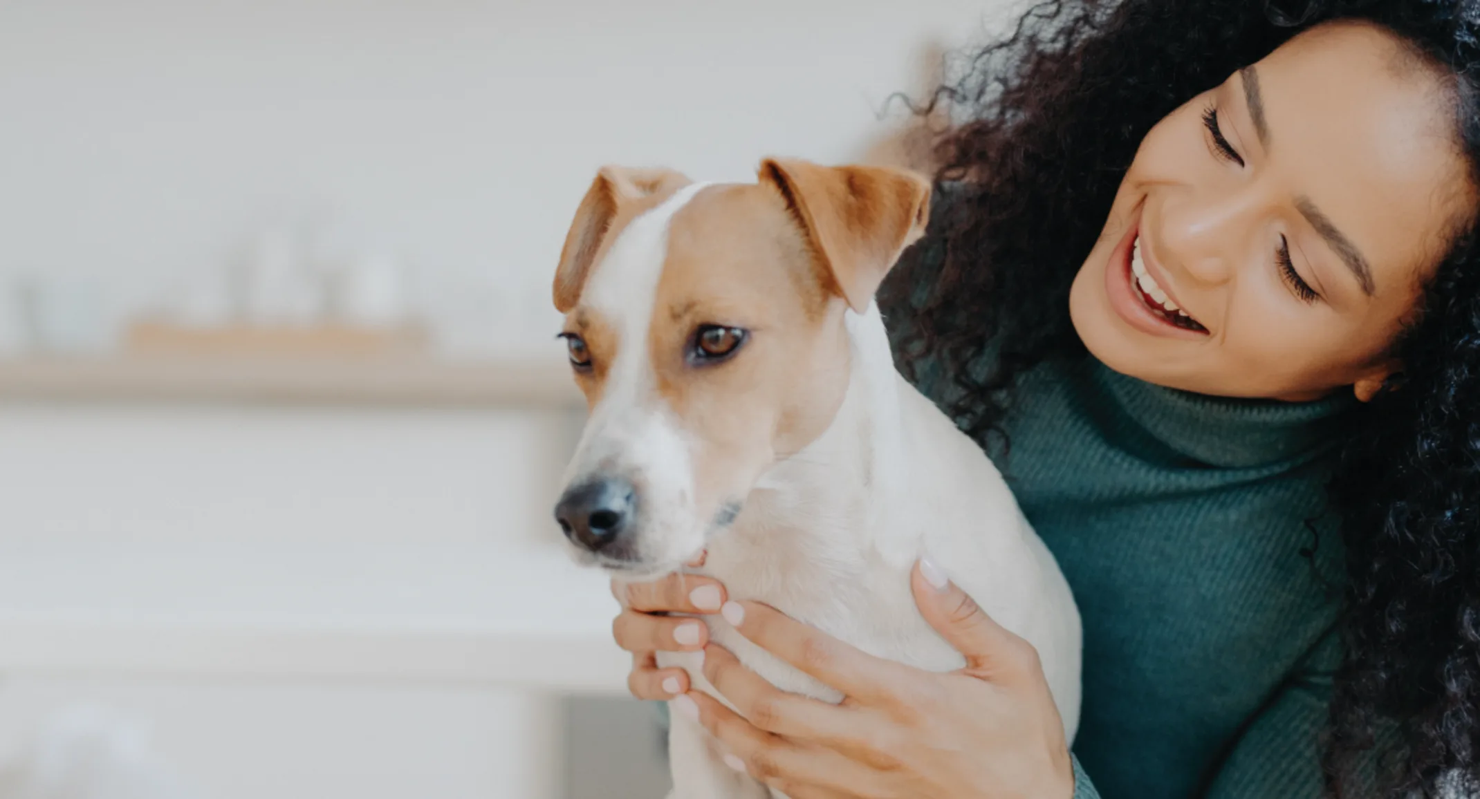 Woman looking at dog holding up