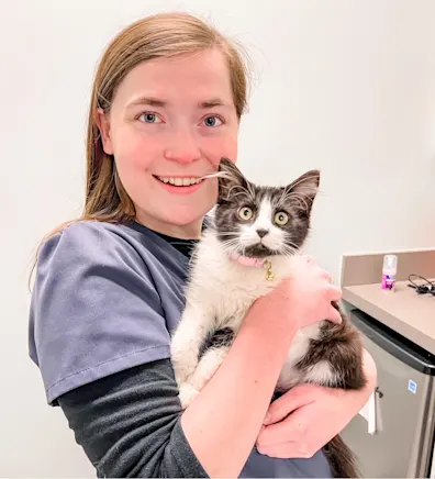 Lindsay Crothers smiling holding a white and brown cat Lindsay Crothers smiling holding a white and brown cat
