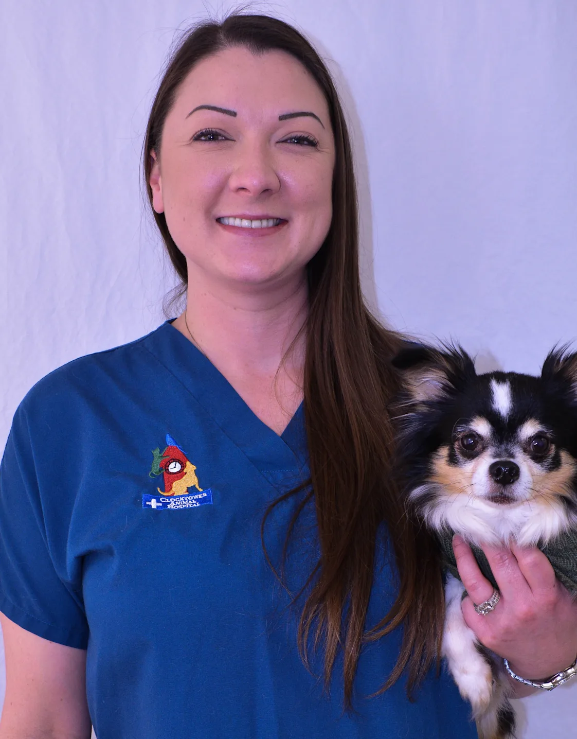 Rachel at Clocktower Animal Hospital, holding a small dog Rachel at Clocktower Animal Hospital, holding a small dog