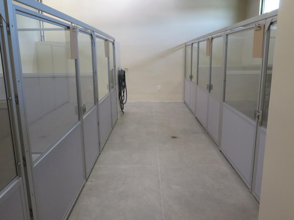 A hallway showing various on both sides of the image showcasing the different rooms for the patients. 