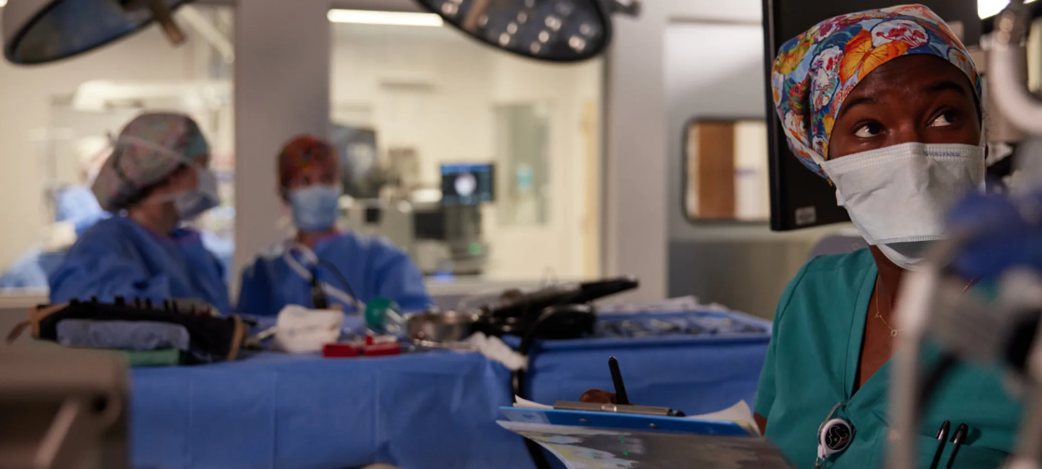 Vet writing on notepad in operating room Vet writing on notepad in operating room