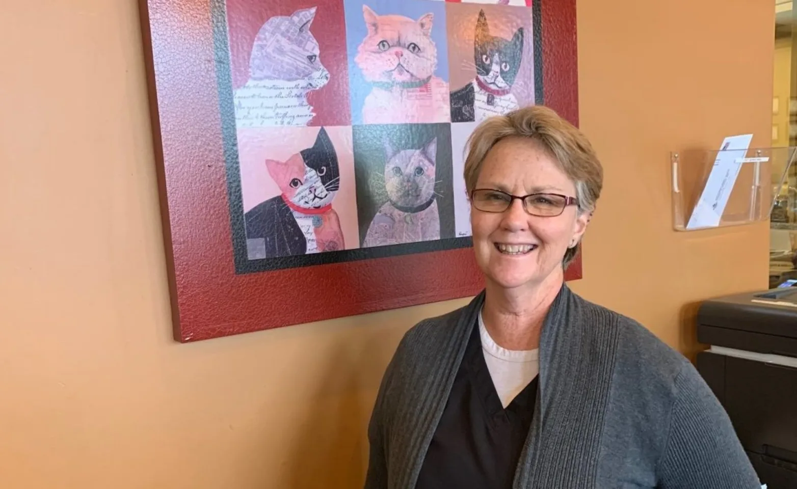 Laura, an employee at Animal House Veterinary Clinic in the lobby area