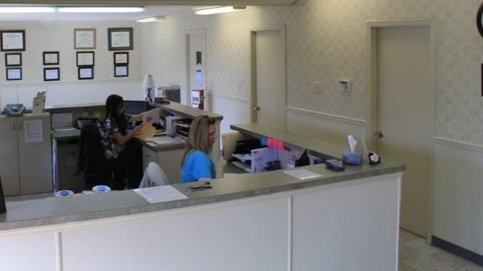 Two members of staff working at the front desk of Eastview Veterinary Clinic
